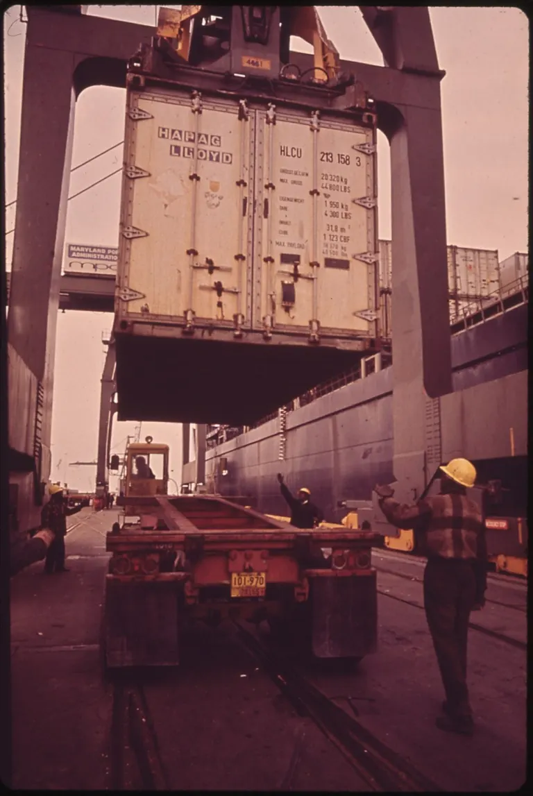 CONTAINER CARGO IS UNLOADED AT DUNDALK MARINE TERMINAL, A MARYLAND PORT AUTHORITY FACILITY NARA 546910